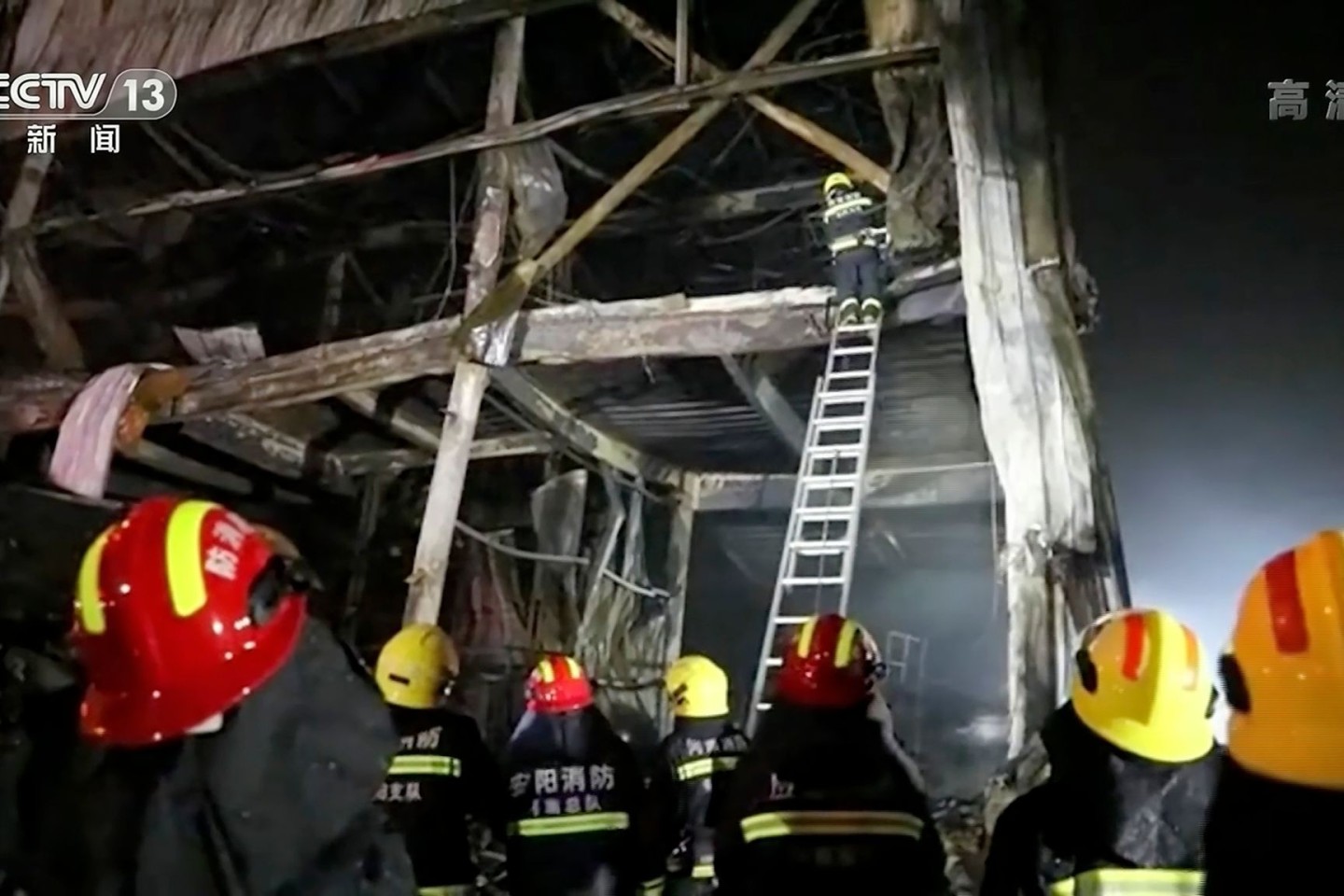 Auf diesem Standbild aus Videoaufnahmen des chinesischen Fernsehsenders CCTV klettern Rettungskräfte mit einer Leiter in die Fabrik.