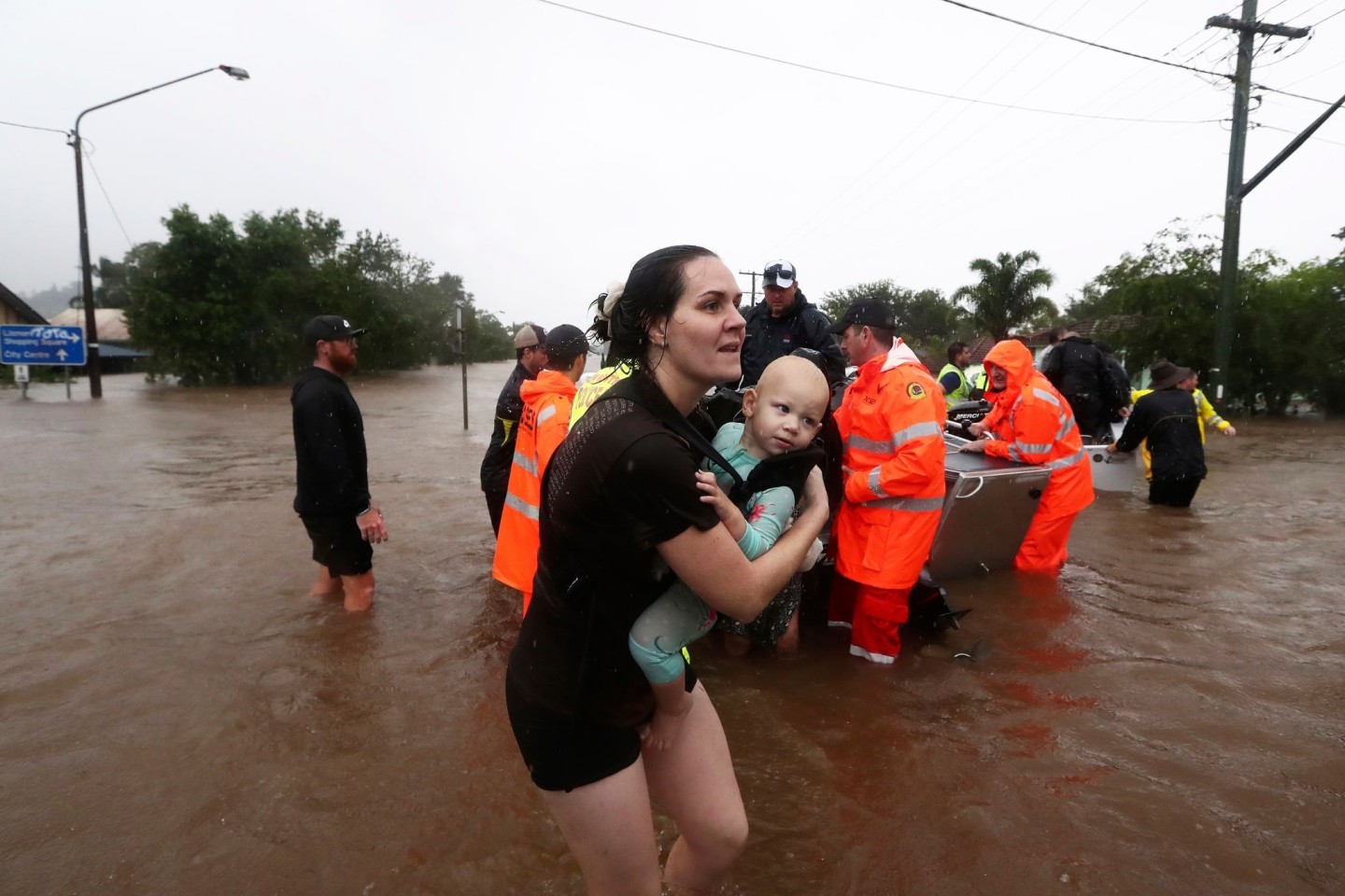 Eine Frau im australischen Lismore sucht mit Baby Schutz vor den Fluten. Sintflutartiger Regen hat die schweren Überschwemmungen im Osten Australiens weiter verschärft.